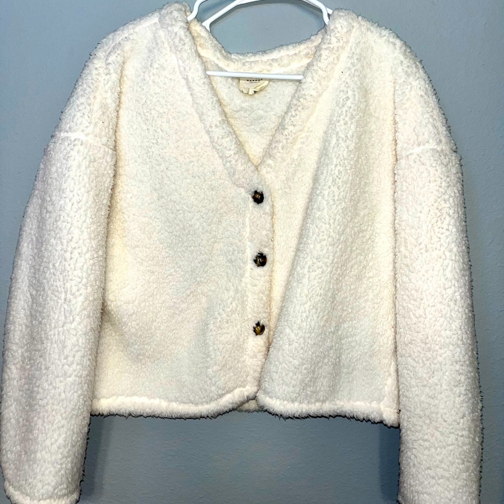 Fuzzy lightweight jacket with buttons down the front.